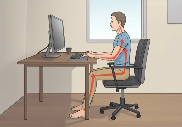 Correct ergonomic posture at a desk while typing.